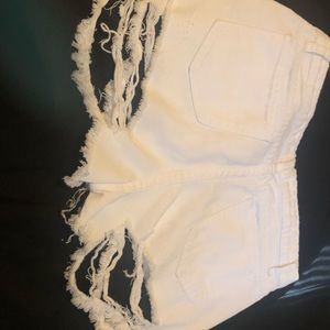 Distressed white jean shorts